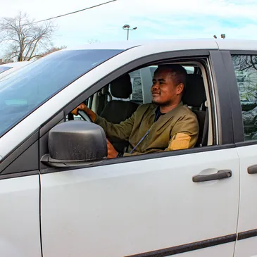 An ITC Transit driver behind the wheel of a company van
