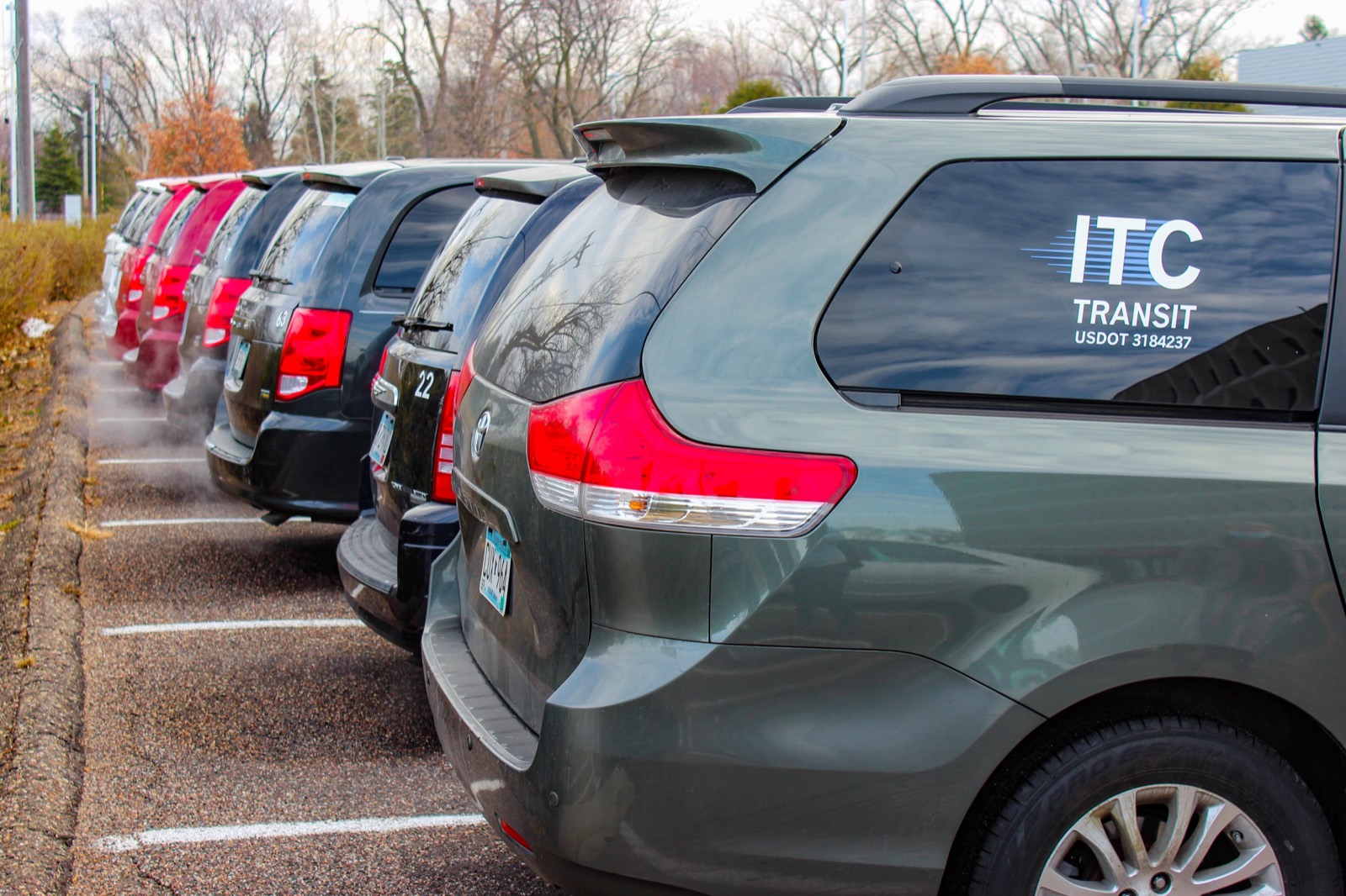A row of ITC Transit vans parked and ready for service